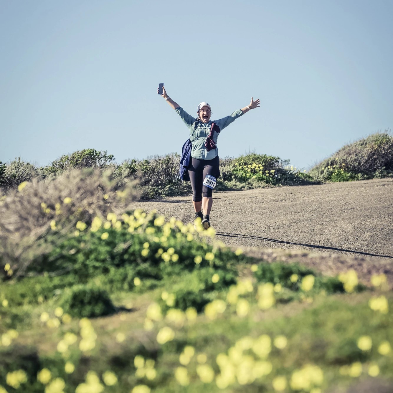 Celebrating with arms raised at the Golden Gate 50K, San Francisco